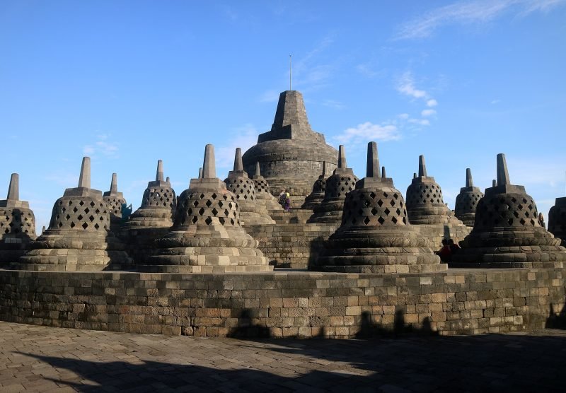The main stupa surrounded by rows of smaller stupas, crowning the Borobudur Buddhist monument in Central Java, Indonesia. The largest Buddhist monument in the world, it was built in the 9th century by the Sailendra dynasty. The upper rounded terrace with rows of bell shaped stupas containing Buddha images symbolize Arupadhatu, the sphere of formlesness, a complete perfection of enlightenment.