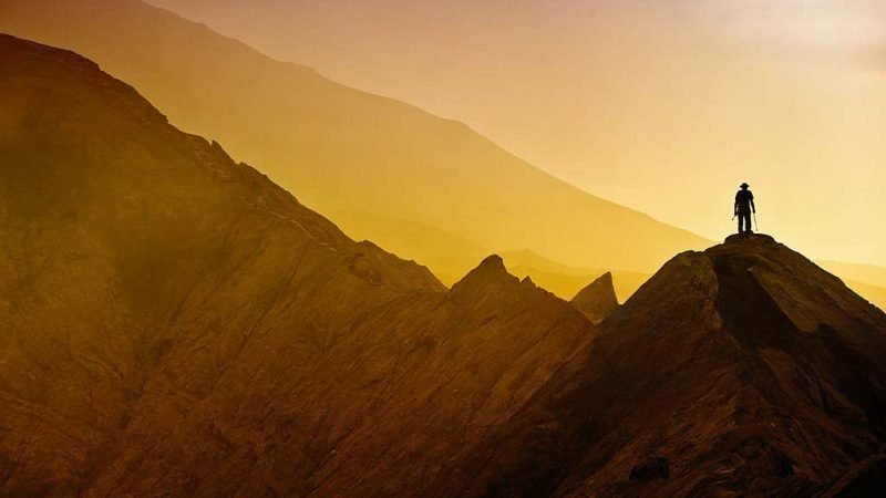 Silhouettes of tourists hiking on Bromo mountain