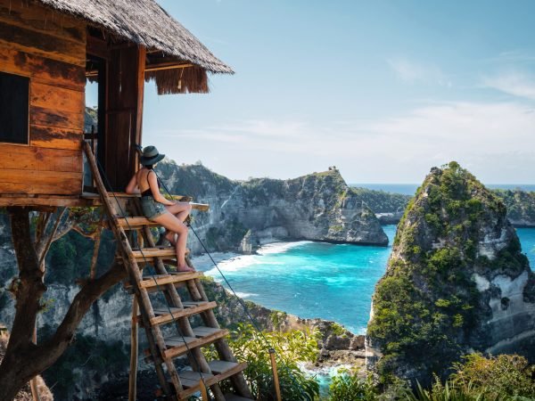 Bali, Indonesia, traveler on tree house at Diamond Beach in Nusa Penida Island.