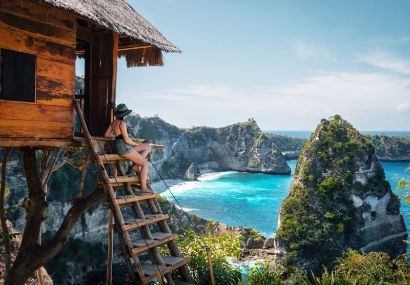 Bali, Indonesia, traveler on tree house at Diamond Beach in Nusa Penida Island.