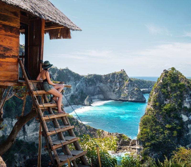 Bali, Indonesia, traveler on tree house at Diamond Beach in Nusa Penida Island.
