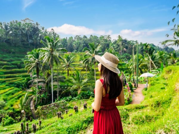 Young,Female,Tourist,In,Red,Dress,Looking,At,The,Beautiful