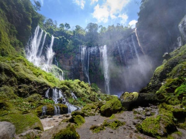 Aerial view deep inside the canyon of the Tumpak Sewu waterfall located in Java, Indonesia. The source of the waterfall comes from Semeru, an active volcano and the highest mountain in Java.