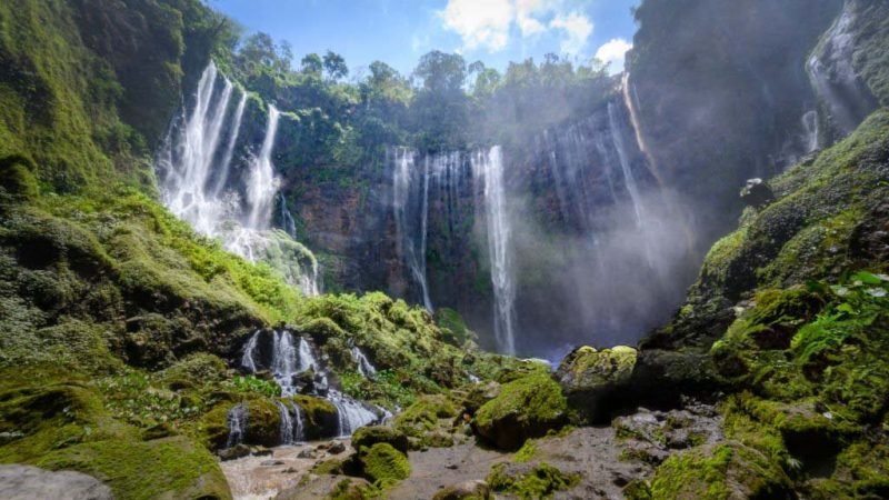 Aerial view deep inside the canyon of the Tumpak Sewu waterfall located in Java, Indonesia. The source of the waterfall comes from Semeru, an active volcano and the highest mountain in Java.