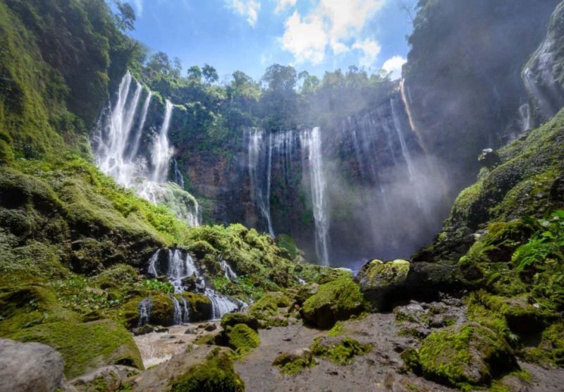 Aerial view deep inside the canyon of the Tumpak Sewu waterfall located in Java, Indonesia. The source of the waterfall comes from Semeru, an active volcano and the highest mountain in Java.