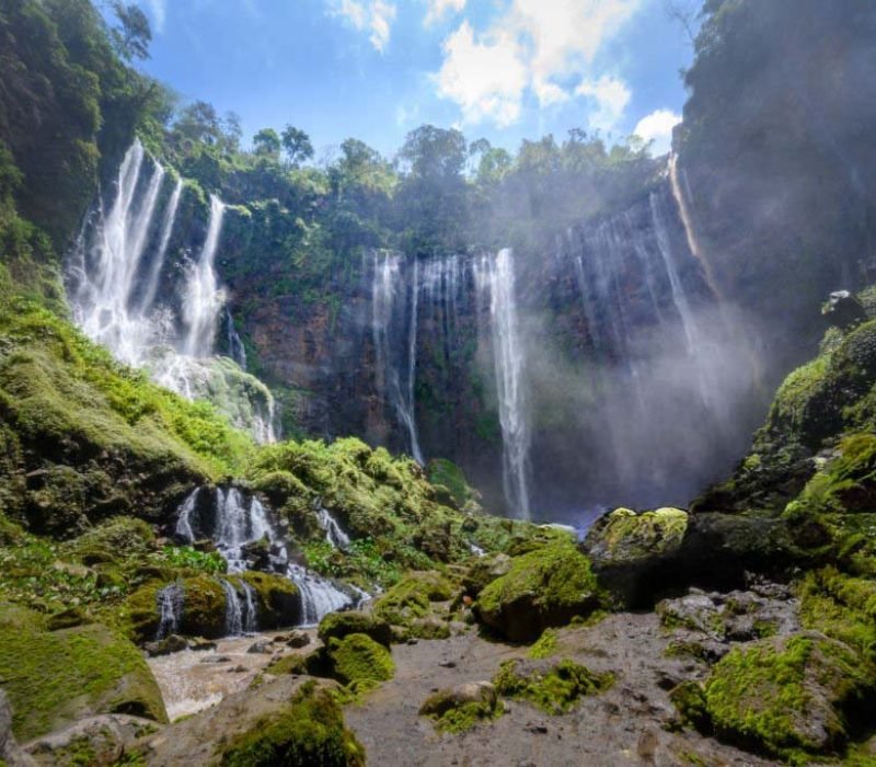 Aerial view deep inside the canyon of the Tumpak Sewu waterfall located in Java, Indonesia. The source of the waterfall comes from Semeru, an active volcano and the highest mountain in Java.